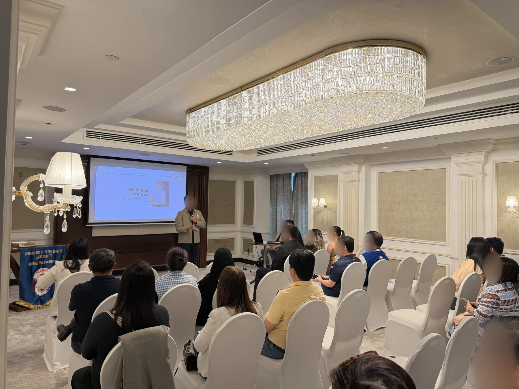 Seminar attendees seated while a speaker presents